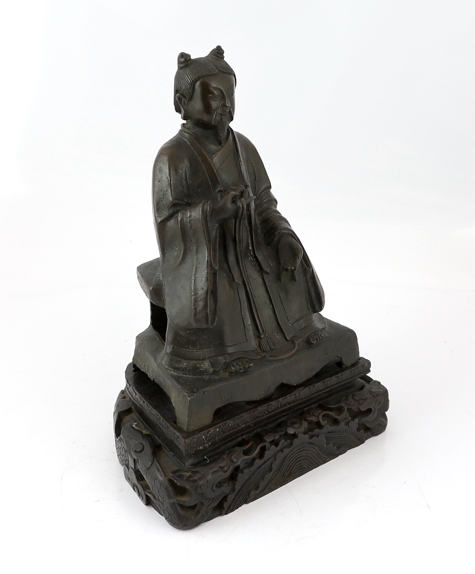 A Chinese bronze figure of a Daoist deity, late Ming, losses to back of throne
